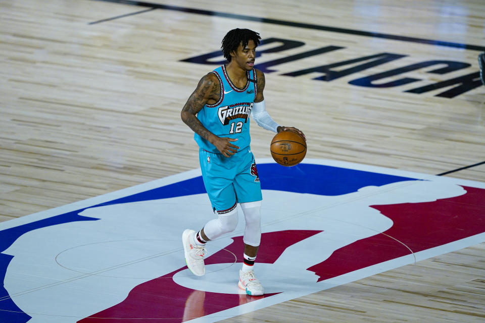 Memphis Grizzlies' Ja Morant (12) brings the ball up court New Orleans Pelicans during the first half of an NBA basketball game Monday, Aug. 3, 2020 in Lake Buena Vista, Fla. (AP Photo/Ashley Landis, Pool)