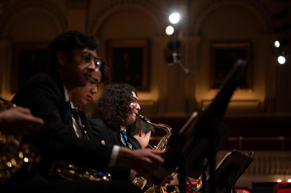 John Oulette, 18, of MIllbury practices saxophone prior to a dress rehearsal at Mechanics Hall.