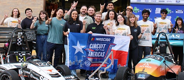 Holding the flag, from left, are Longhorn Racing Vice President Navya Agrawal, NASCAR driver Tyler Reddick and Longhorn Racing public relations officer Fatima Sanchez at the UT Engineering and Teaching Center on Thursday. Some of Longhorn Racing's cars were on display.