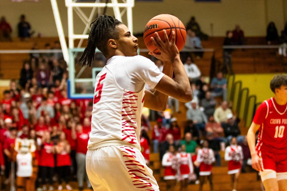 Fishers' Jason Gardner (5) lines up a shot during the Fishers vs. Crown Point boys semistate basketball semifinal game Saturday, March 16, 2024 at Northside Gym in Elkhart.