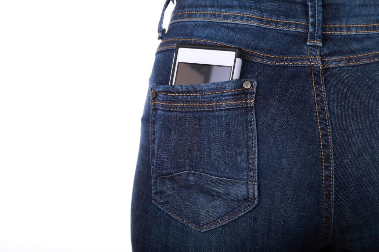 A phone that's been tucked into a tight-fitted jeans back pocket.