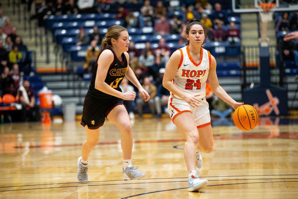 Calvin's Alyssa Karner gives chase to Hope's Lina Rea as the final minutes of the fourth quarter wind down Wednesday, Feb. 8, 2023, at DeVos Fieldhouse. 