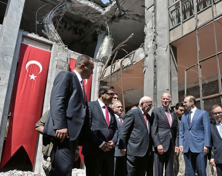 U.S. Vice President Joe Biden (3rd R) and Turkey's is accompanied by Turkey's Parliament Speaker Ismail Kahraman (4th R) as he visits damaged parts of the Turkish Parliament in Ankara, Turkey, August 24, 2016. REUTERS/Stringer