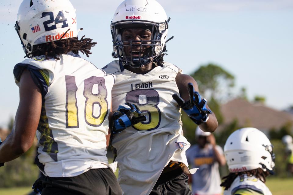 Lehigh Senior High School football players Jeremy Ware and James Little celebrate at practice on Tuesday, Aug. 1, 2023, in Lehigh Acres. (Syndication: The News-Press)