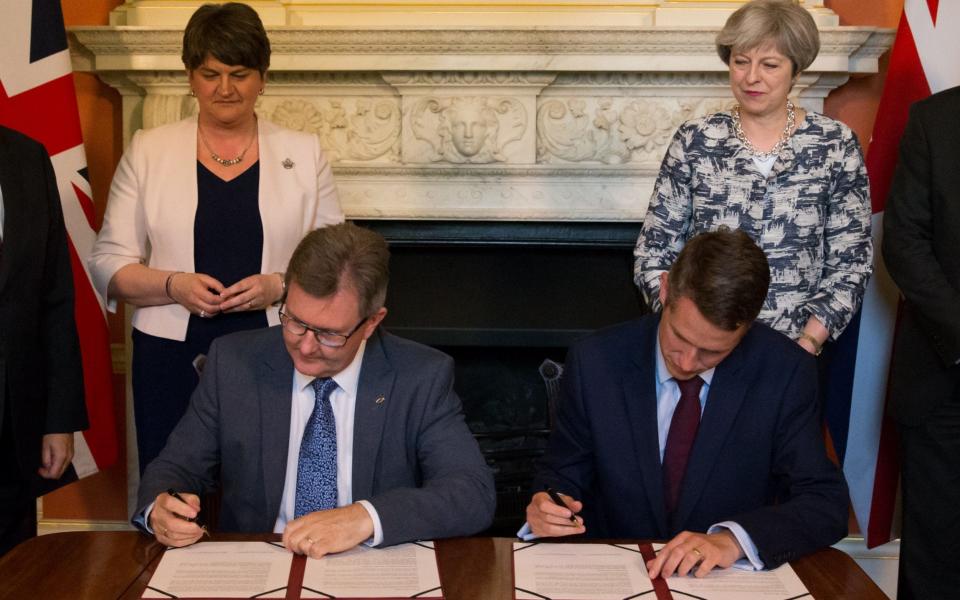 Prime Minister Theresa May with DUP leader Arlene Foster (left), as DUP MP Sir Jeffrey Donaldson (second right) and Parliamentary Secretary to the Treasury, and Chief Whip, Gavin Williamson, signing paperwork inside 10 Downing Street, London, after the DUP agreed a deal to support the minority Conservative government - Credit: Daniel Leal-Olivas/PA