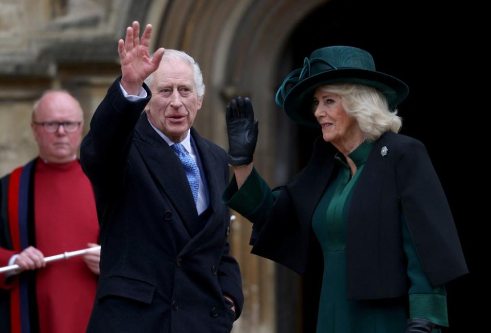 King Charles and Queen Camilla wave to the crowd before entering the Easter Mattins Service at Windsor Castle on Sunday. Getty Images