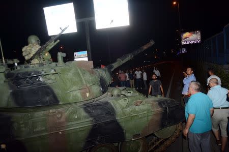 A crowd forms in front of a Turkish armoured vehicle at Ataturk airport in Istanbul, Turkey July 16, 2016. REUTERS/IHLAS News Agency