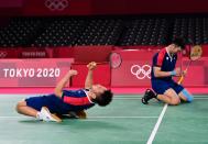 <p>TOPSHOT - Taiwan's Lee Yang (L) and Taiwan's Wang Chi-lin celebrate winning their men's doubles badminton semi-final match against Indonesia's Mohammad Ahsan and Indonesia's Hendra Setiawan during the Tokyo 2020 Olympic Games at the Musashino Forest Sports Plaza in Tokyo on July 30, 2021. (Photo by Pedro PARDO / AFP) (Photo by PEDRO PARDO/AFP via Getty Images)</p> 