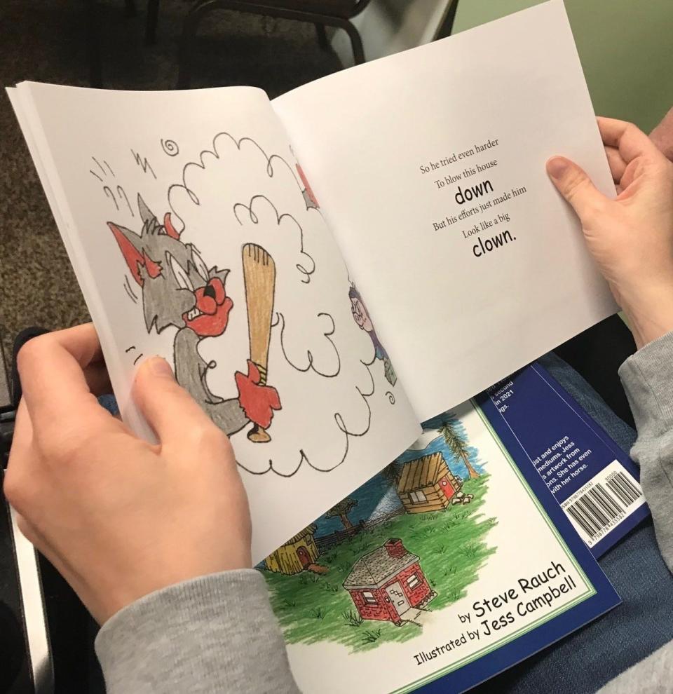 Artist Jess Campbell shows off some of her work featured in the new children's book X Church Care and Outreach Pastor Steve Rauch wrote. The book is called "The Three Little People Pigs."