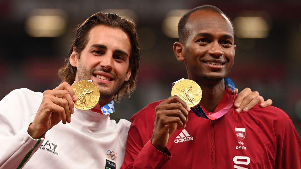 Gianmarco Tamberi (L) and Mutaz Essa Barshim agreed to share the men's high jump gold at the Tokyo 2020 Olympic Games. - INA FASSBENDER/AFP/AFP via Getty Images