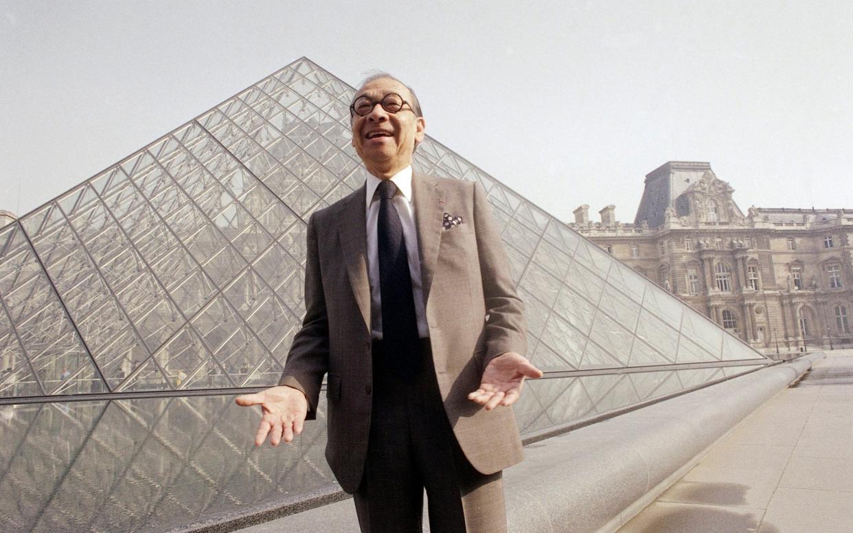 I.M. Pei laughs while posing for a portrait in 1989 in front of the Louvre glass pyramid, which he designed, in the museum's Napoleon Courtyard, 1989 - AP