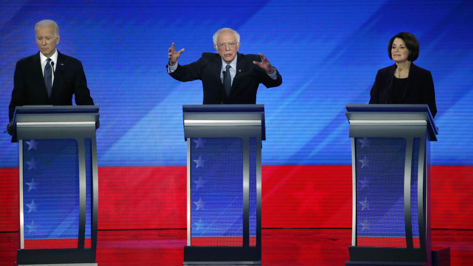 Democratic presidential candidate Sen. Bernie Sanders, I-Vt., center, speaks as former Vice President Joe Biden, left, and Sen. Amy Klobuchar, D-Minn., listen during a Democratic presidential primary debate, Friday, Feb. 7, 2020, hosted by ABC News, Apple News, and WMUR-TV at Saint Anselm College in Manchester, N.H. (AP Photo/Elise Amendola)