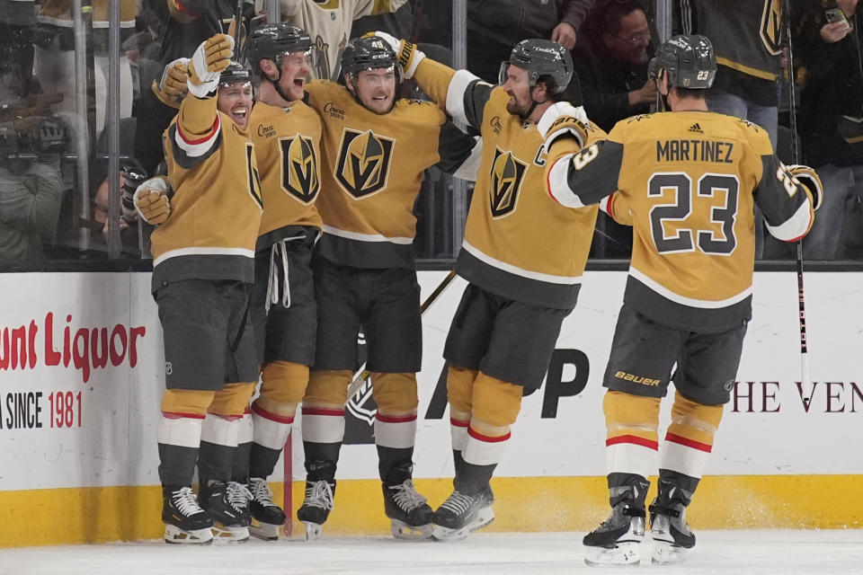 Vegas Golden Knights center Jack Eichel, second from left, celebrates after scoring against the Boston Bruins during the third period of an NHL hockey game Thursday, Jan. 11, 2024, in Las Vegas. (AP Photo/John Locher)
