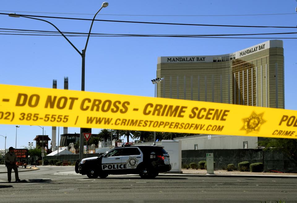 <p>Crime scene tape surrounds the Mandalay Hotel (background with shooters window damage top right) after a gunman killed dozens of people and wounded hundreds when he opened fire on a country music concert in Las Vegas, Nev. on Oct. 2, 2017. (Photo: Mark Ralston/AFP/Getty Images) </p>