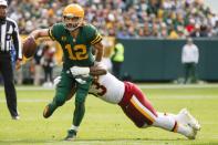 Washington Football Team's Jonathan Allen stops Green Bay Packers' Aaron Rodgers during the first half of an NFL football game Sunday, Oct. 24, 2021, in Green Bay, Wis. (AP Photo/Matt Ludtke)