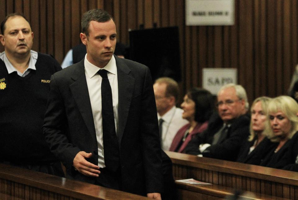 Oscar Pistorius arrives for his trial at the high court in Pretoria, South Africa, Monday, March 3, 2014. Pistorius is charged with murder with premeditation in the shooting death of girlfriend Reeva Steenkamp in the pre-dawn hours of Valentine's Day 2013. (AP Photo/Themba Hadebe, Pool)