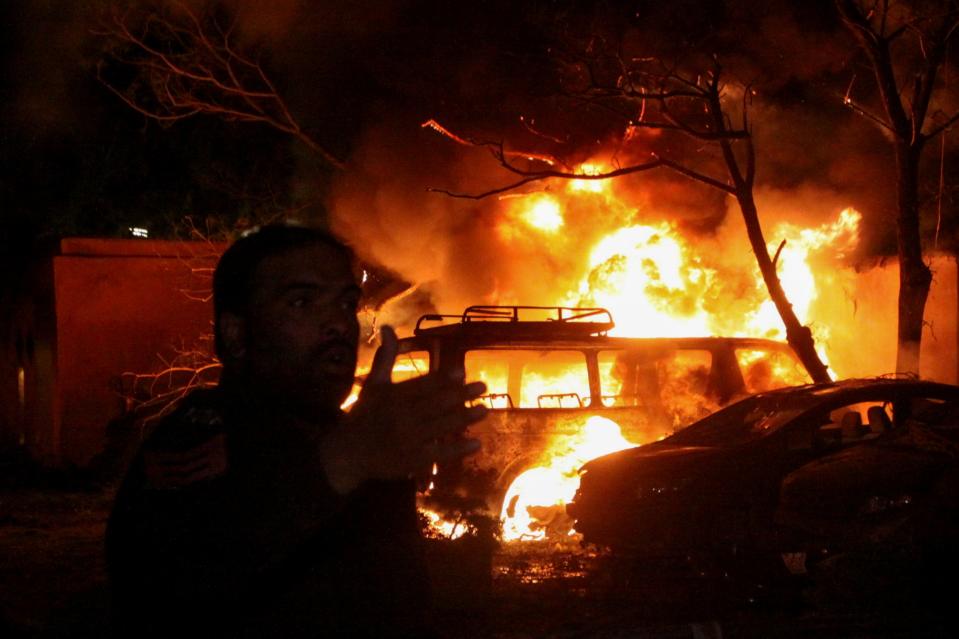 <p>A police officer reacts after an explosion at a luxury hotel in Quetta, Pakistan </p> (Reuters)