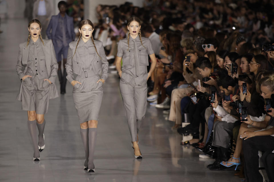 Models Candice Swanepoel, from left, Gigi Hadid and Doutzen Kroes wear creations as part of the Max Mara Spring-Summer 2020 collection, unveiled during the fashion week, in Milan, Italy, Thursday, Sept. 19, 2019. (AP Photo/Luca Bruno)