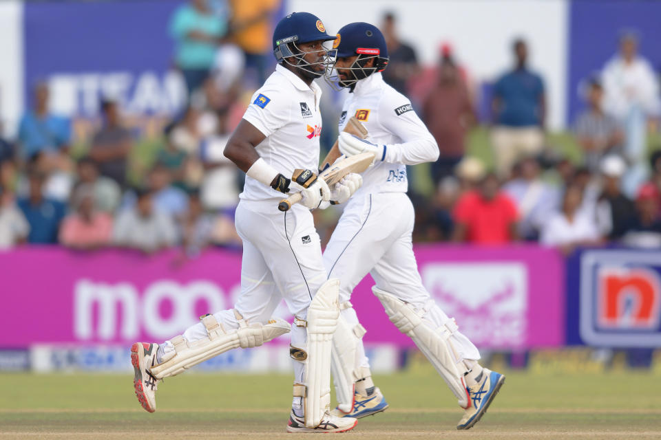 Sri Lanka's captain Dhananjaya de Silva, right, and teammate Angelo Mathews run between the wickets on the third day of the first cricket test match between New Zealand and Sri Lanka in Galle, Sri Lanka, Friday, Sept. 20, 2024. (AP Photo/Viraj Kothalawala)