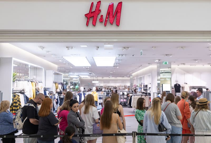 People line up to enter an H&M store in Moscow