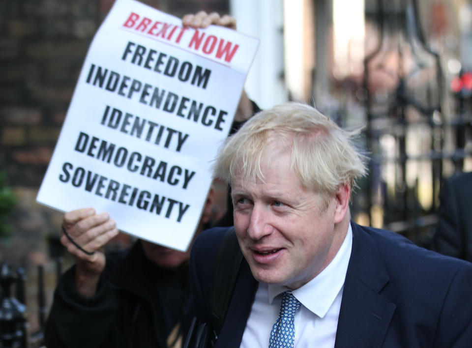 Conservative party leadership contender Boris Johnson, is shadowed by a Brexit demonstrator, as he arrives at his office in central London, Tuesday July 23, 2019. Britain’s governing Conservative Party is set to reveal the name of the country’s next prime minister later Tuesday, with Brexit champion Boris Johnson widely considered to be favourite to get the job against fellow contender Jeremy Hunt. (Yui Mok/PA via AP)