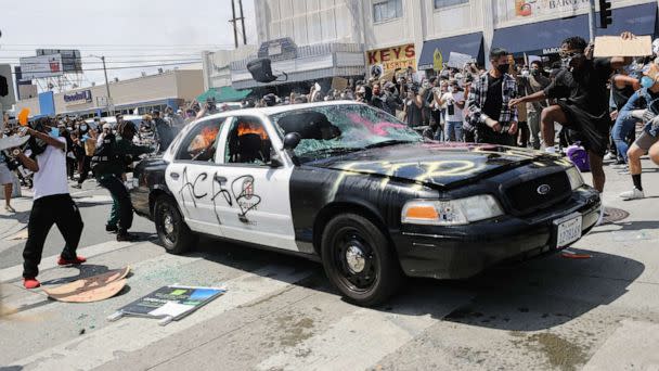 PHOTO: An LAPD vehicle begins to burn after being set alight by protestors during demonstrations following the death of George Floyd, May 30, 2020, in Los Angeles. (Mario Tama/Getty Images)