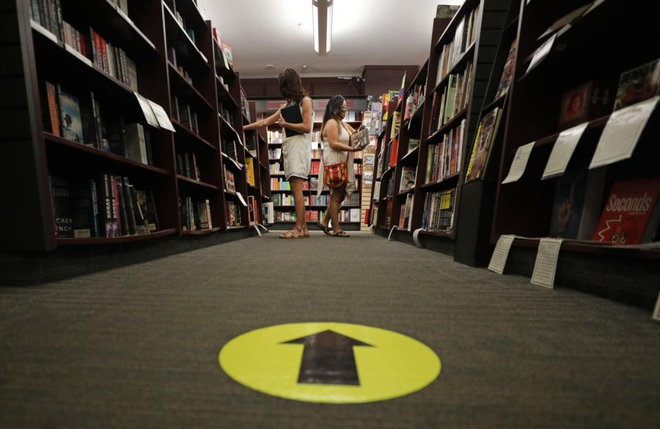 Friends Abigail Boydston, left, and Robyn Kiyomi shop at Vroman's Bookstore in Pasadena