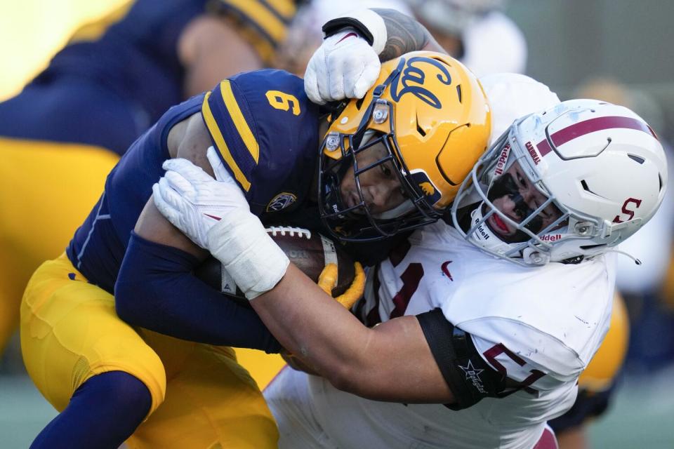 Stanford defensive lineman Jaxson Moi tackles California running back Jaydn Ott during a game in November 2022.