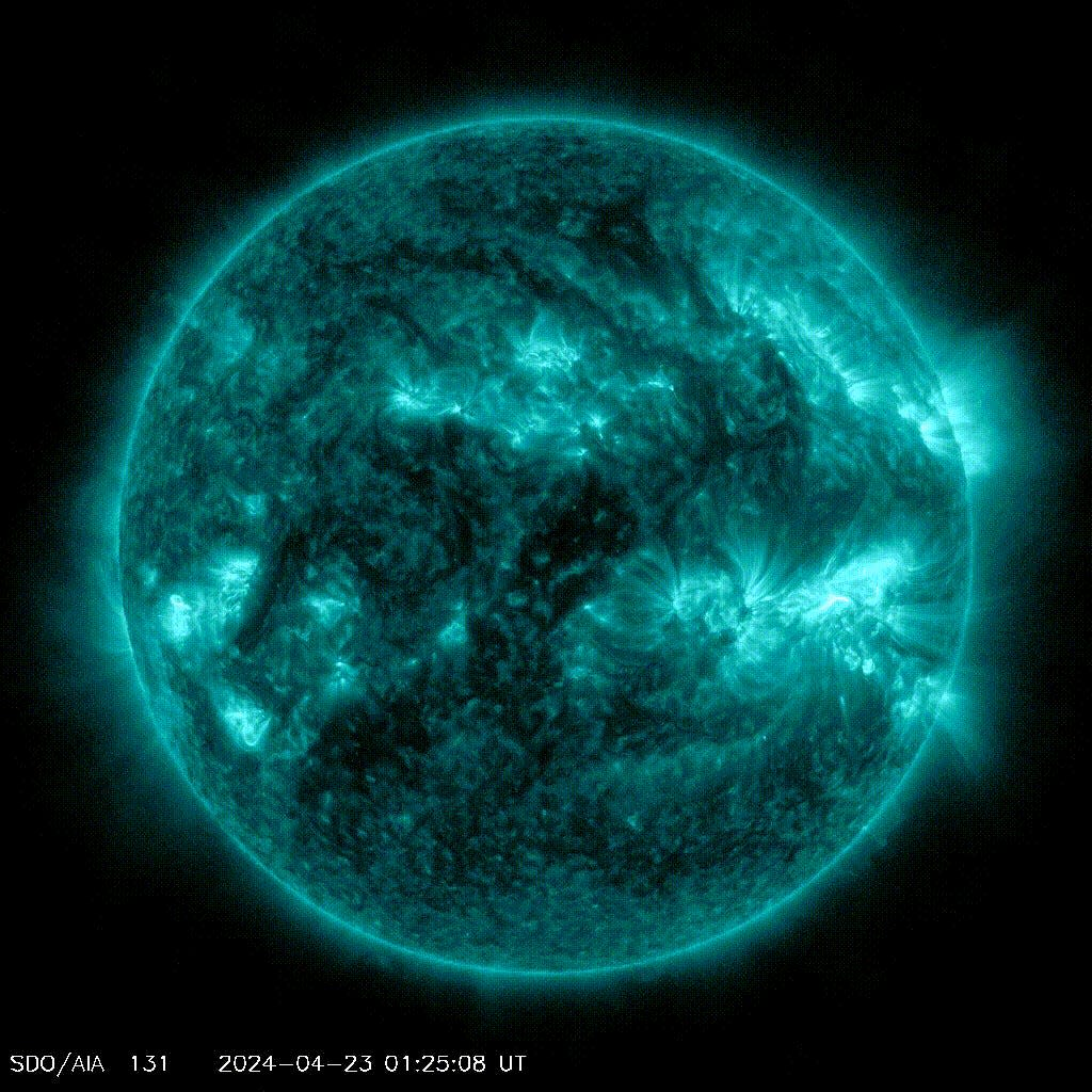 gif of rotating blue sun shows sudden bright flashes from four regions of roiling bright blue light on the sun's disc