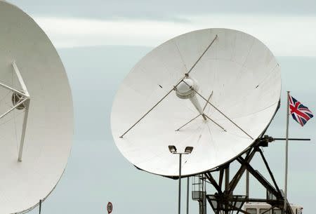 FILE PHOTO: Satellite dishes are seen at GCHQ's outpost at Bude, southwest England, June 23, 2013. REUTERS/Kieran Doherty/File Photo