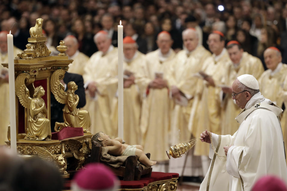 Pope Francis spreads incense in front of a statue of Baby Jesus as he celebrates the Christmas Eve Mass in St. Peter's Basilica at the Vatican, Monday, Dec. 24, 2018. (AP Photo/Alessandra Tarantino)