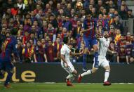 Football Soccer - Barcelona v Real Madrid - Spanish La Liga Santander- Nou Camp Stadium, Barcelona, Spain - 3/12/16. Barcelona's Sergio Busquets and Real Madrid's Karim Benzema and Lucas Vazquez in action during the "Clasico". REUTERS/Sergio Perez