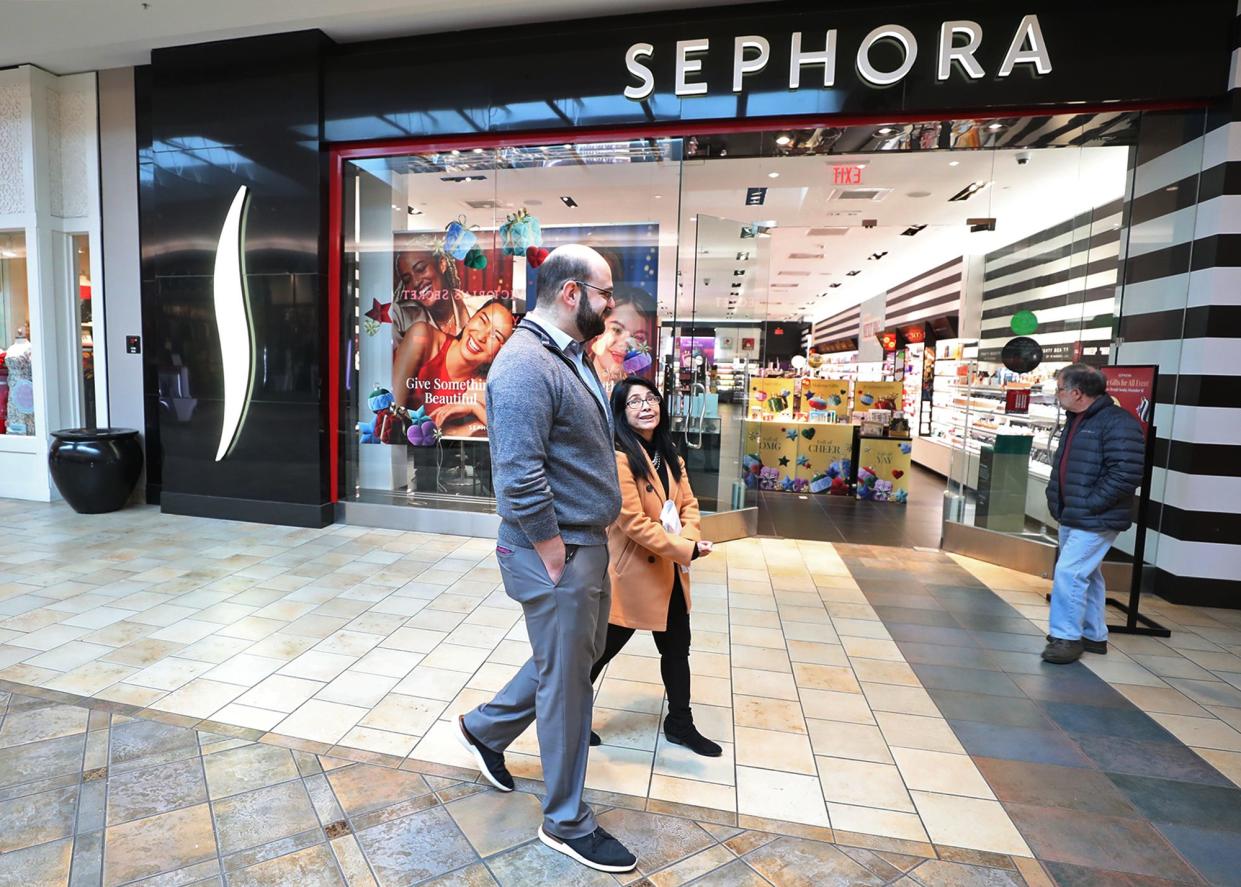 Kyle Hersh, area director of marketing and business development at Summit Mall, and Rose Cline, marketing assistant, walk the mall as they talk about new tenants that will be opening in the coming months.