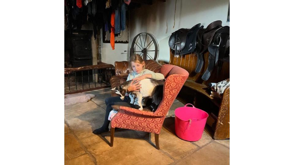 Amanda Owen's daughter cuddling her goat