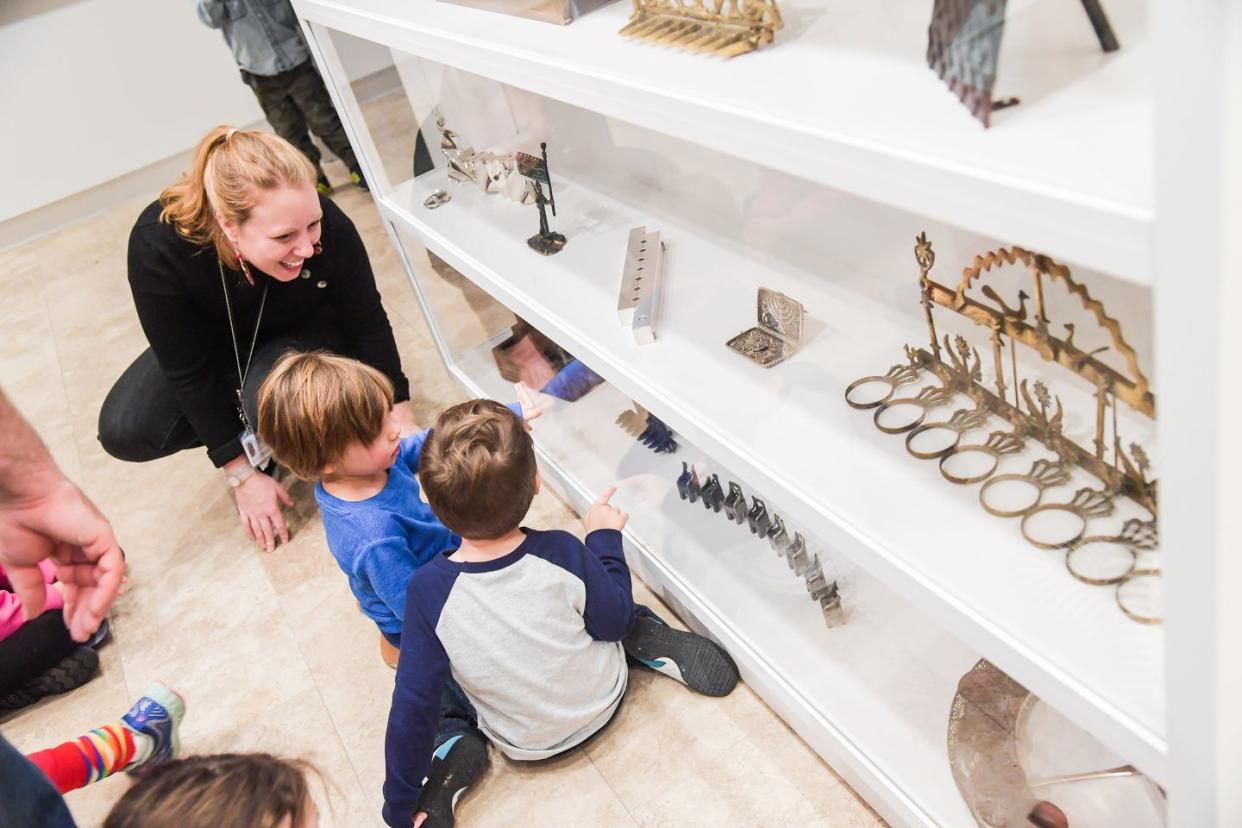 a woman and two children at a museum