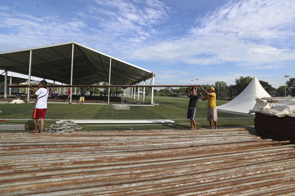 Labors work to construct a temporary quarantine center for people infected or suspected of carrying the new coronavirus, at a football stadium, in Yangon, Myanmar Monday, Sept. 14, 2020. Authorities in Yangon, Myanmar’s biggest city, are expanding quarantine facilities as new cases of the coronavirus have risen to more than 100 a day. (AP Photo/Thein Zaw)