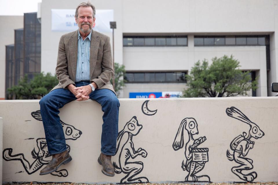 Bob Diven, former cartoonist for the Las Cruces Sun-News, poses for a portrait by one of his murals on Wednesday, August 23, 2023.