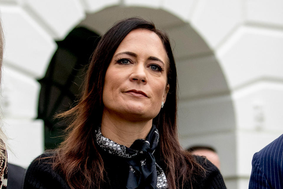 In this Oct. 3, 2019 file photo, White House press secretary Stephanie Grisham listens as President Donald Trump speaks to the media on the South Lawn of the White House in Washington. Grisham is leaving her post after never holding a single press briefing. Grisham will be assuming a new role as chief of staff to first lady Melania Trump. (AP Photo/Andrew Harnik)