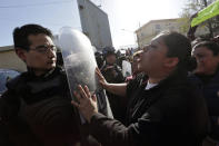 A family member of an inmate pushes the shield of a police officer outside the Topo Chico prison in Monterrey, Mexico, February 11, 2016. REUTERS/Daniel Becerril