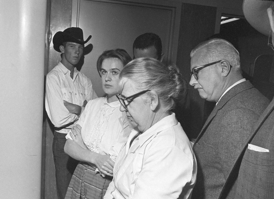 Marina Oswald is shown with her mother-in-law, Marguerite Claverie Oswald, in the police station in Dallas where her husband, Lee Harvey Oswald is accused in the assassination of President John F. Kennedy, Nov. 22, 1963. Men are unidentified. (Photo: AP)