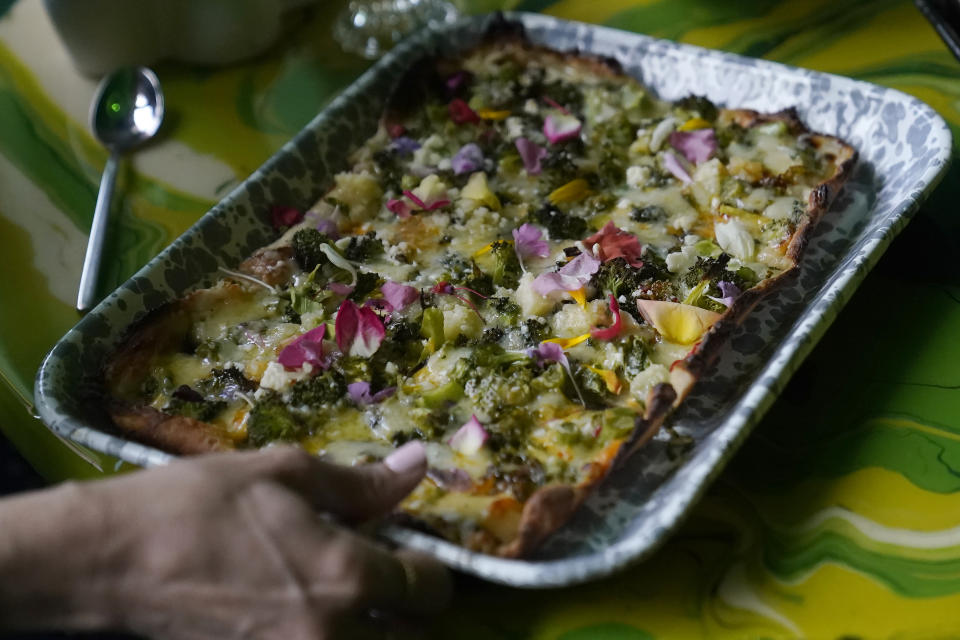 A Cheddah and Feta Trash Pie pizza is shown at Shuggie's Trash Pie restaurant in San Francisco, Wednesday, June 14, 2023. World Upcycling Day is June 24, celebrating the repurposing of old products into something new. This year, the movement is focusing on upcycling food, like misshapen produce or offcuts of meat, as a way to prevent food waste. (AP Photo/Jeff Chiu)