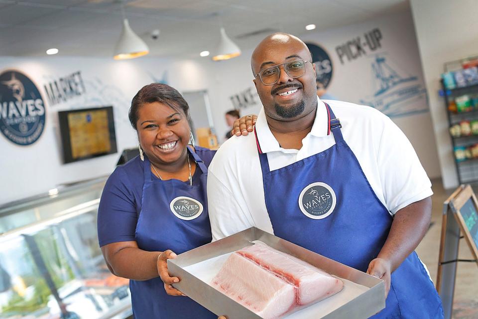 Kara and Ray Kelley, owners of Waves Seafood in Braintree, with fresh swordfish.