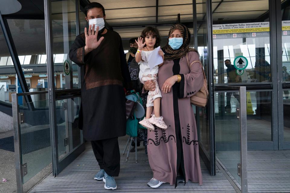 Families evacuated from Kabul at Washington Dulles International Airport in Chantilly, Va., on Aug. 30, 2021. (AP Photo/Jose Luis Magana) ORG XMIT: VAJL117