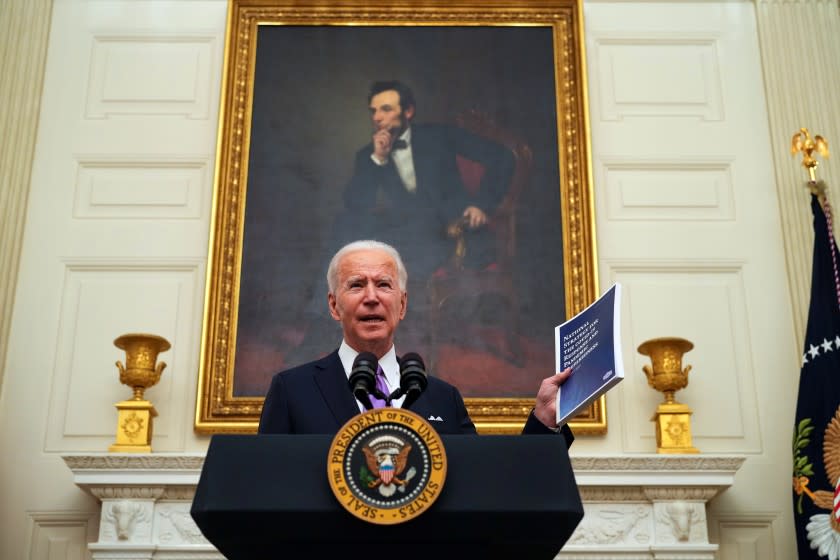 President Joe Biden talks about his administration's COVID-19 response as he displays a copy of the plan during an event at the White House in Washington on Thursday, Jan. 21, 2021. President Biden is using his first full day in office on Thursday to begin taking charge of the campaign against the coronavirus, promising to use the kind of centralized authority that the Trump administration had shied away from. (Doug Mills/The New York Times)