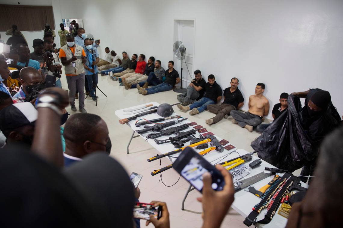 In this July 8, 2021, photo, suspects in the assassination of Haiti’s President Jovenel Moïse are shown to the media, along with the weapons and equipment they allegedly used in the attack, at police headquarters in Port-au-Prince, Haiti.