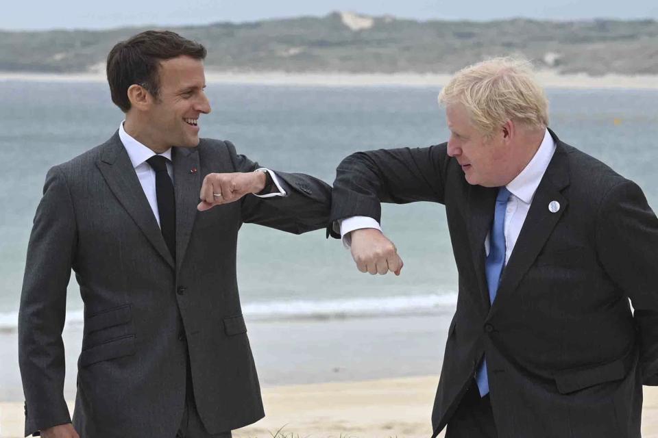 Britain's Prime Minister Boris Johnson, right greets French President Emmanuel Macron prior to the Leaders official welcome and group photo session, during the G7 summit, in Carbis Bay, Cornwall, England, Friday, June 11, 2021. (Leon Neal/Pool Photo via AP)