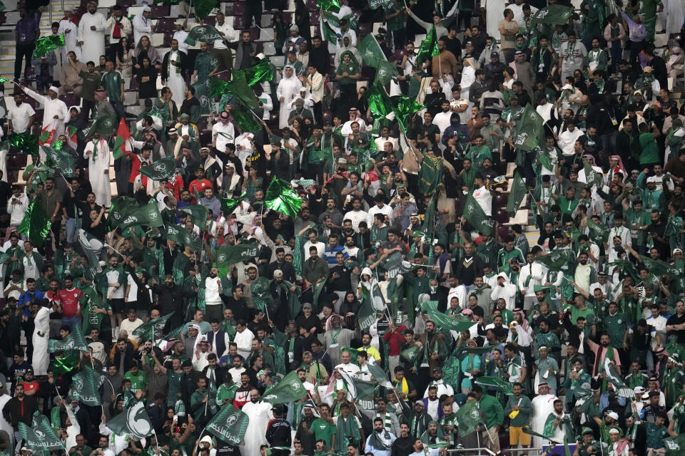 Saudi Arabia fans celebrate the second goal of their national team during the Asian Cup Group F soccer match between Saudi Arabia and Oman at Khalifa International Stadium in Doha, Qatar, Tuesday, Jan. 16, 2024. (AP Photo/Aijaz Rahi)