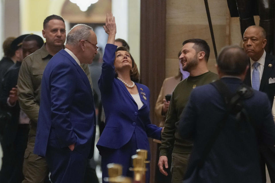 Ukraine's President Volodymyr Zelenskyy, right, looks towards Speaker of the House Nancy Pelosi, of Calif., center, as she point upwards during a visit to the Rotunda at the Capitol in Washington, Wednesday, Dec. 21, 2022. Also with them is Senate Majority Leader Chuck Schumer of N.Y., left.(AP Photo/Jacquelyn Martin)