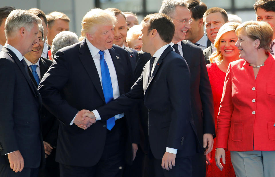 <p>President Donald Trump jokes with French President Emmanuel Macron about their handshakes in front of NATO leaders, including German Chancellor Angela Merkel, NATO Secretary General Jens Stoltenberg (2nd R) and Belgium King Philippe (L), at the start of the NATO summit at their new headquarters in Brussels, Belgium, May 25, 2017. (Photo: Jonathan Ernst/Reuters) </p>