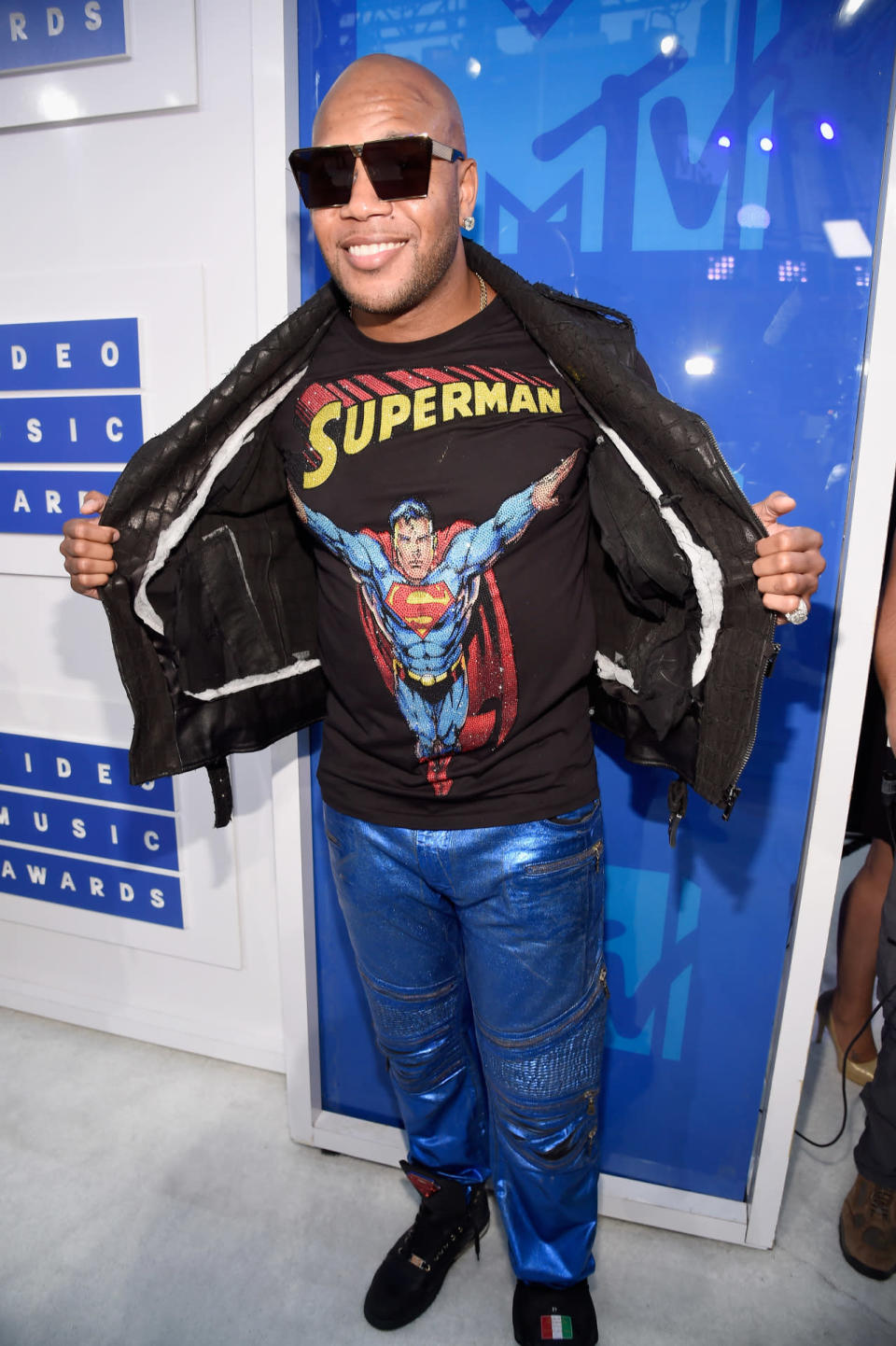 Flo Rida wearing a Superman T-shirt and metallic blue pants. 